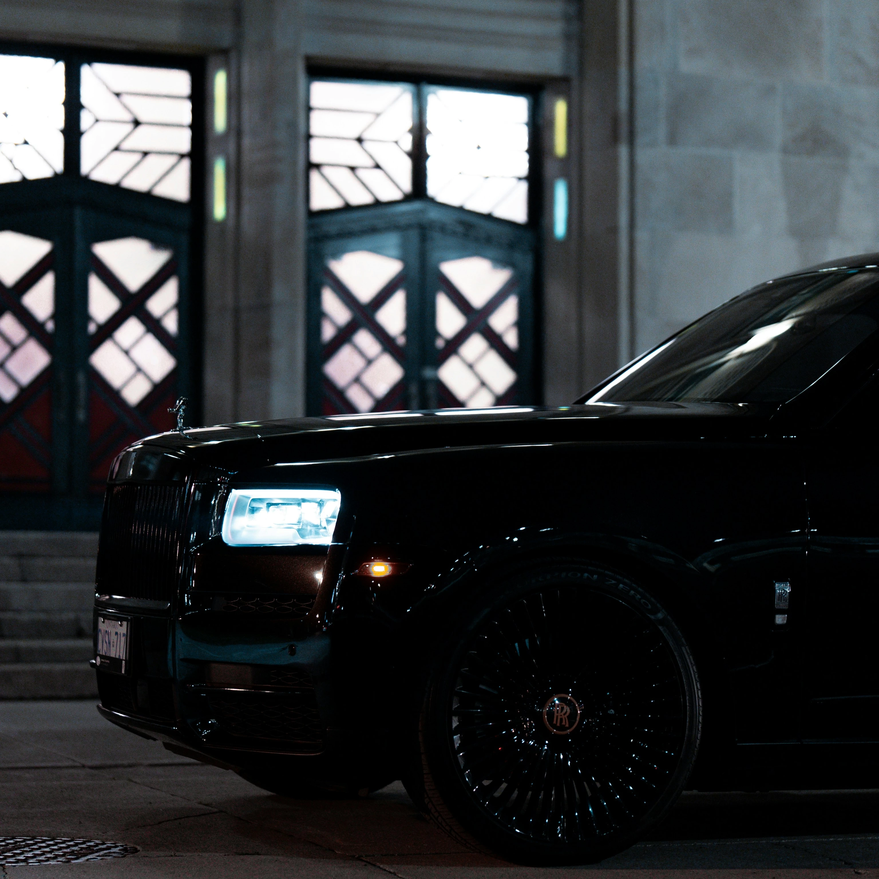 a black suv parked in front of a building