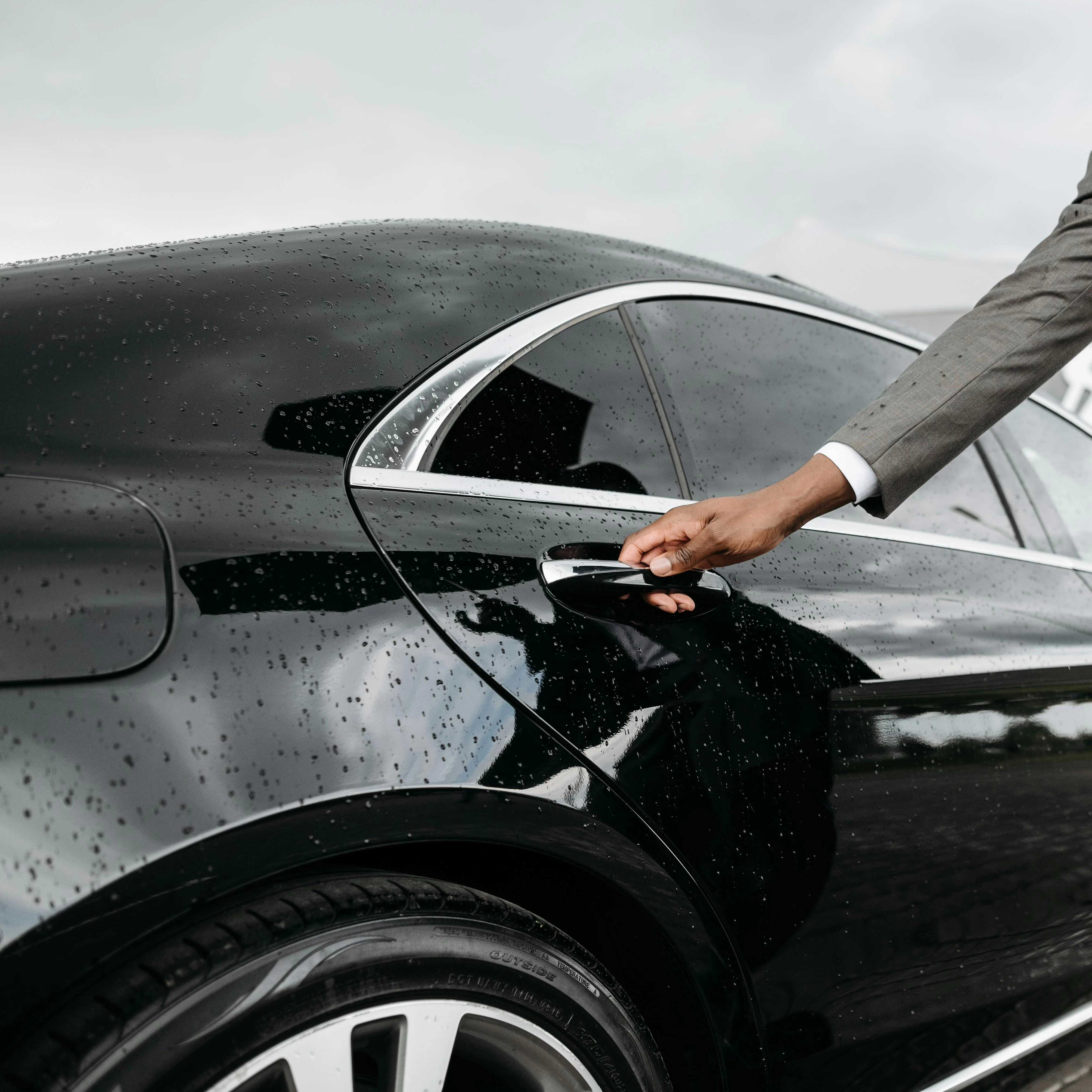 Man Opening a Car Door